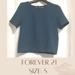 Small blue/green tank top. The back has buttons from top to bottom. Business